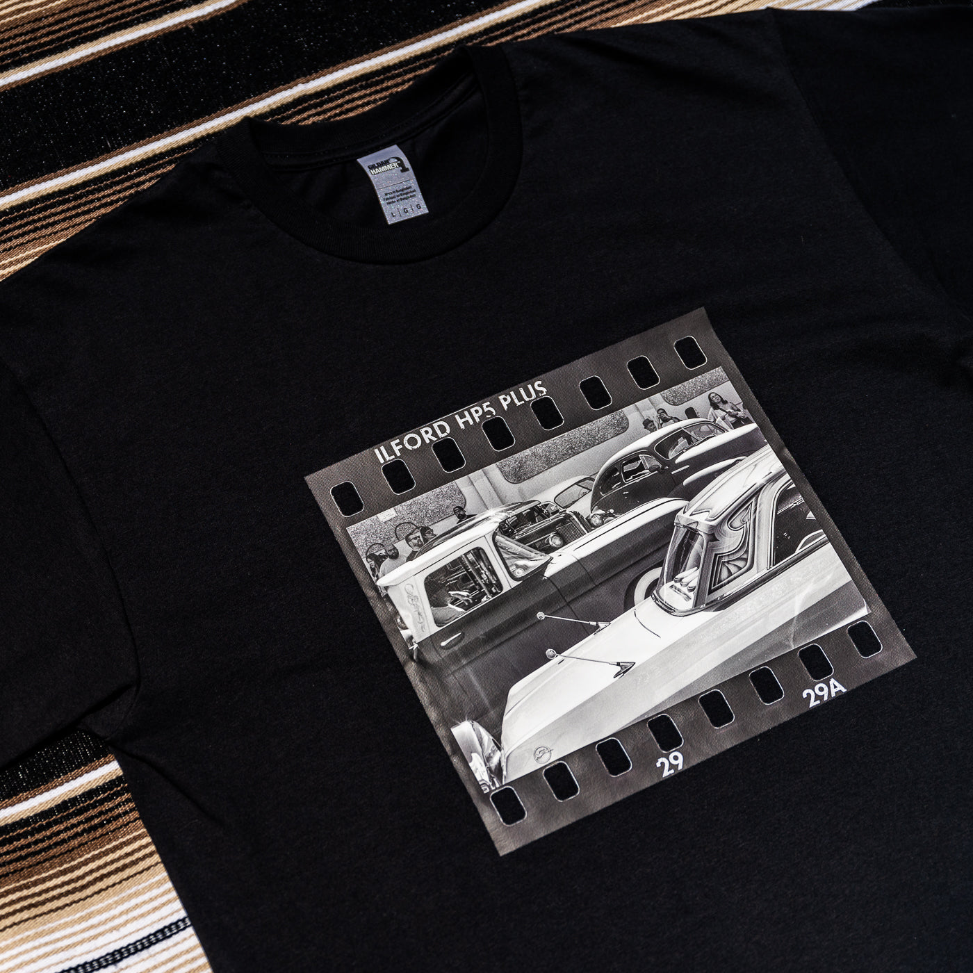 A black t-shirt with a photograph of a vintage car on it.