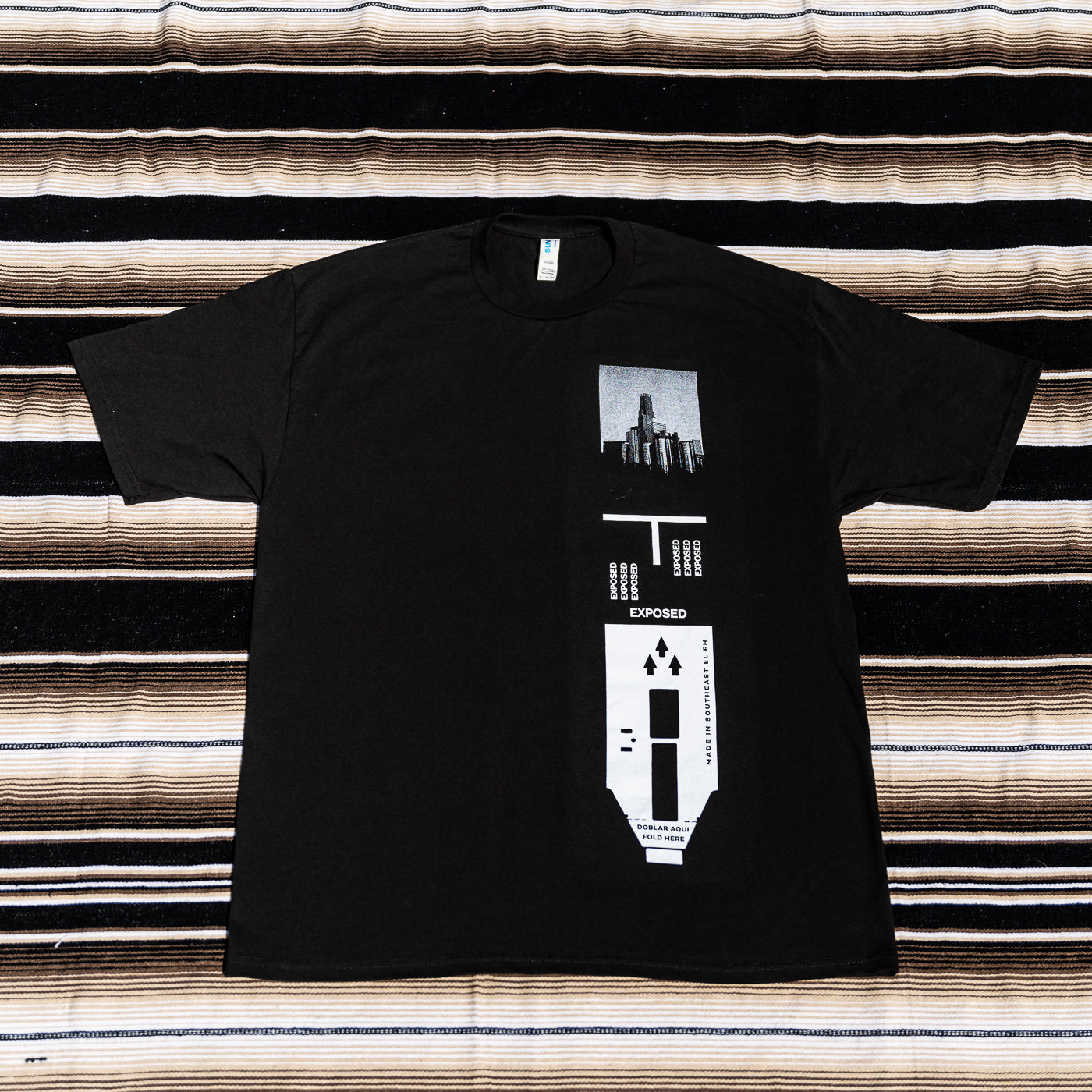 A black t-shirt with a graphic print of a 120 film