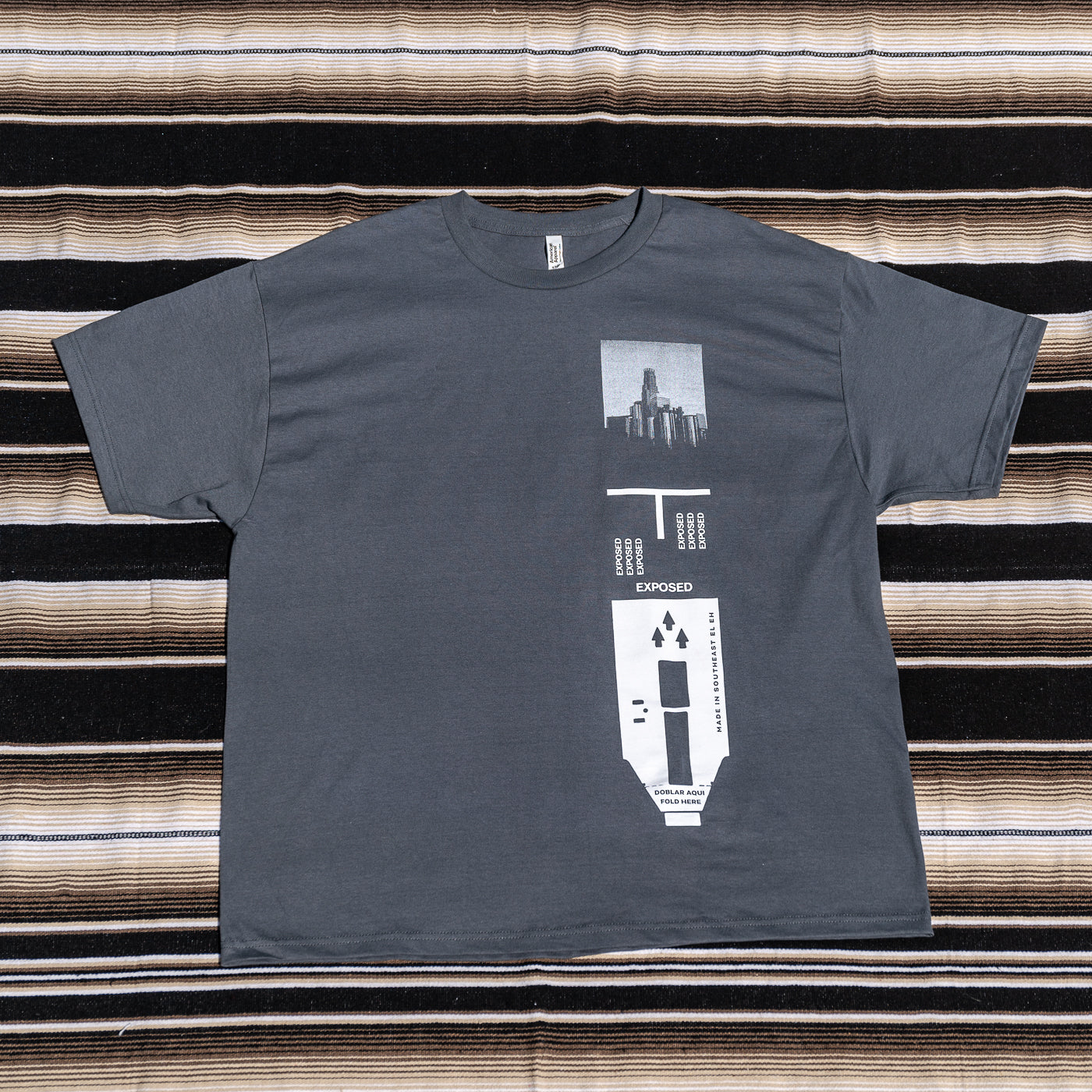 A gray t-shirt with a graphic print of a 120 film.