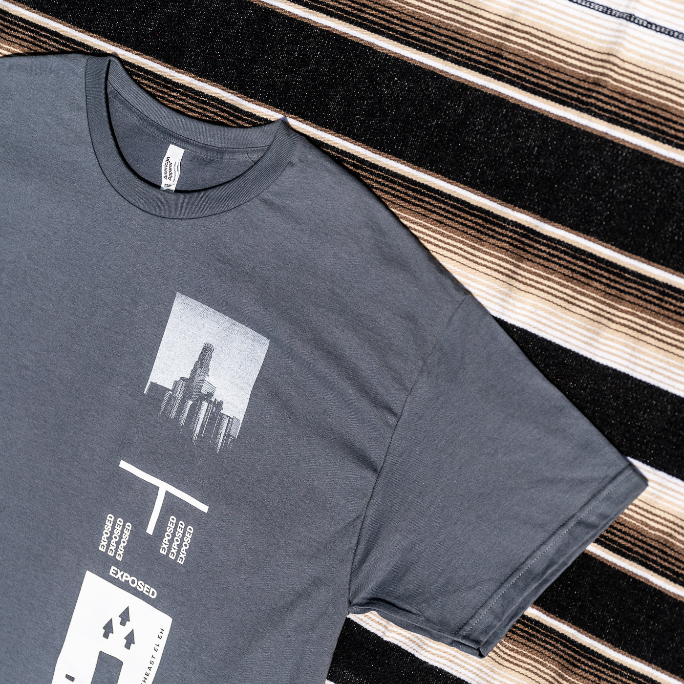 A gray t-shirt with a graphic print on it. 