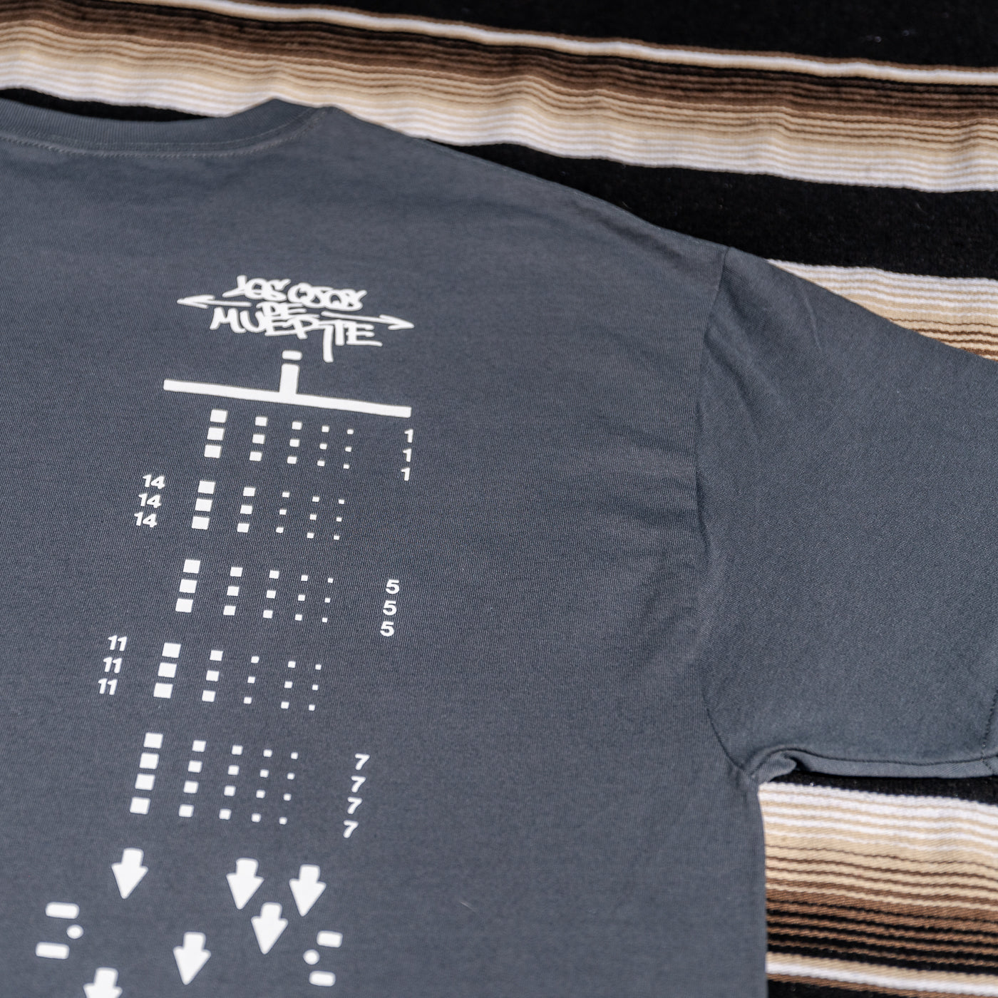 A gray t-shirt with a graphic print of a 120 film.