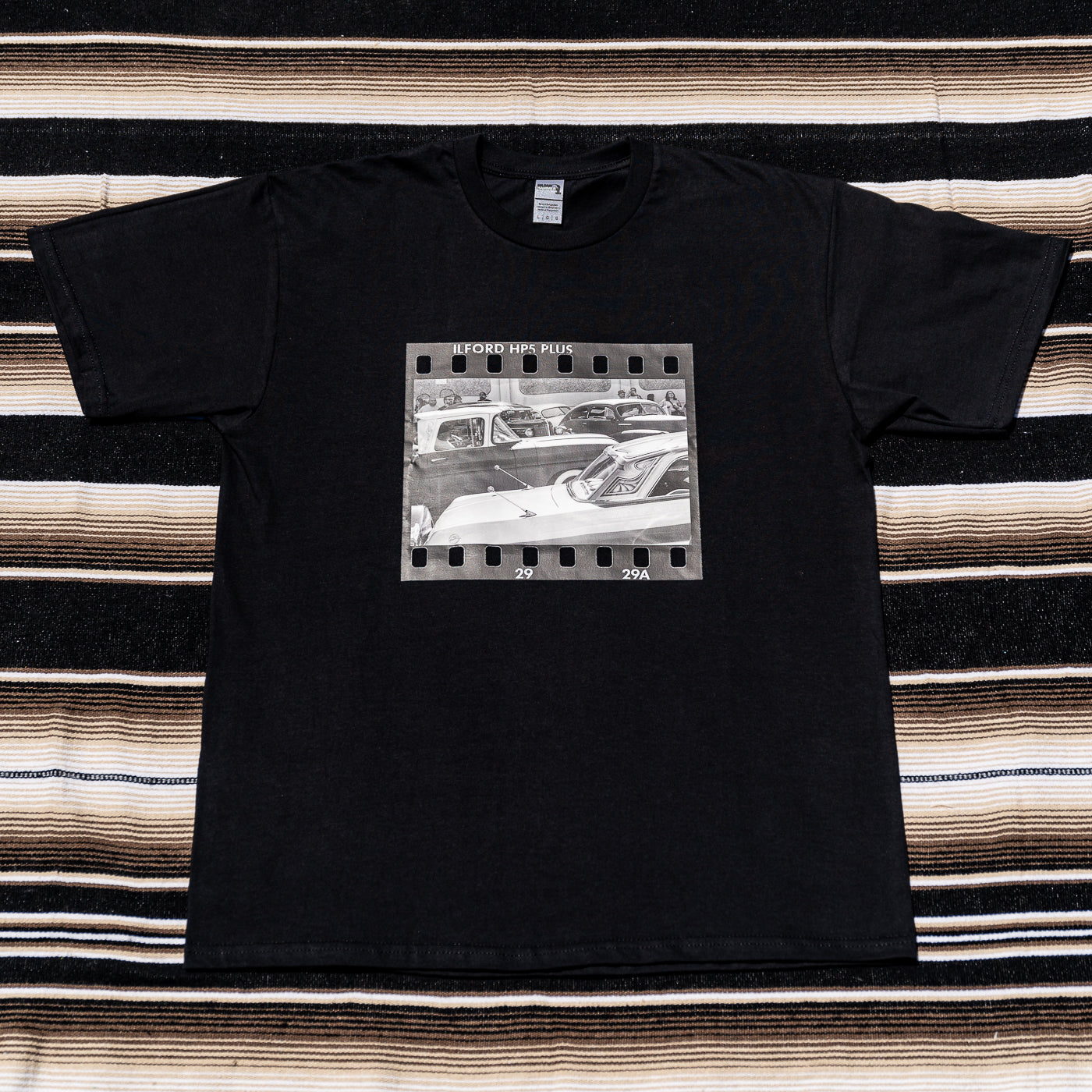 A black t-shirt with a photograph of a vintage car on it.