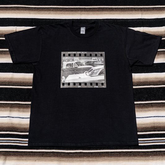 A black t-shirt with a photograph of a vintage car on it.