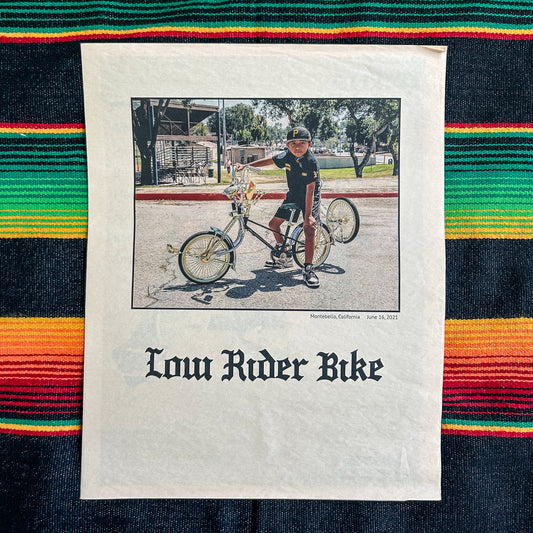 Low Rider Bike zine with a photograph of a person on a lowrider bike. 