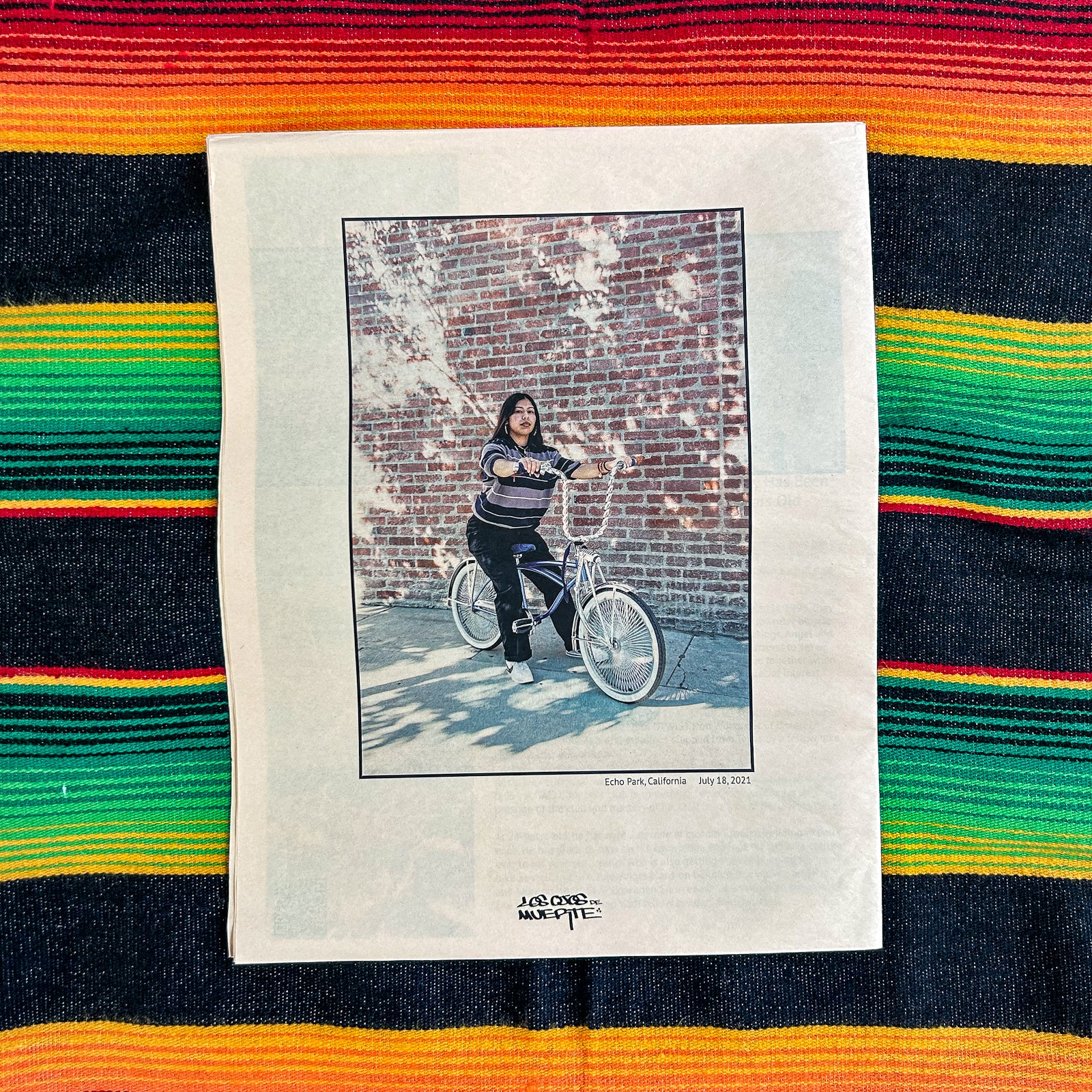 Back cover photo of a person on a lowrider bike. 